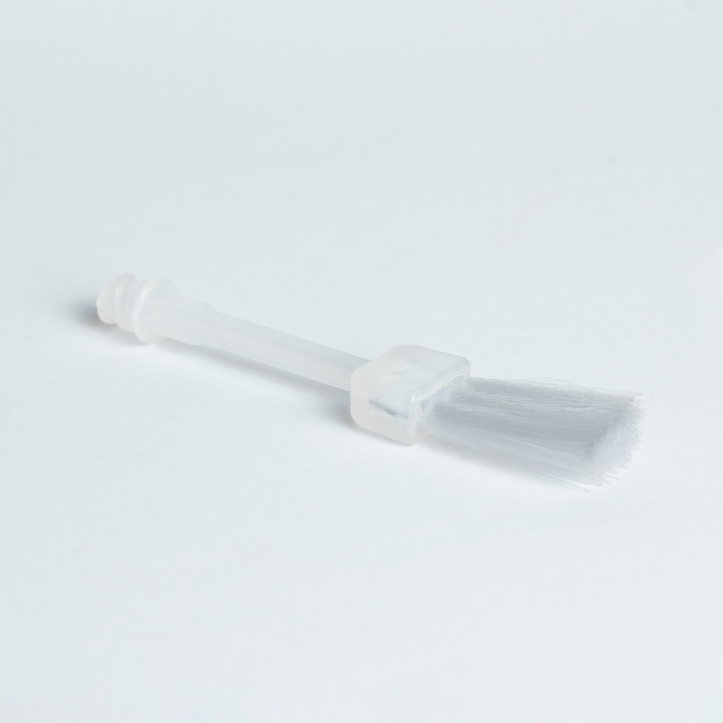 Bosko replacement PVC glue brush angled view showing flat bristle head and clear handle stem close-up
